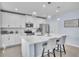 Kitchen featuring stainless steel appliances, white cabinetry, quartz countertop island with barstool seating at 9401 La Salle St, Groveland, FL 34736