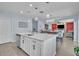 Kitchen island with seating and open concept view of the dining and living areas at 9401 La Salle St, Groveland, FL 34736