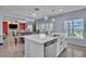 Kitchen island featuring a sink and dishwasher, with open views of the dining and living areas at 9401 La Salle St, Groveland, FL 34736