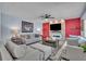 Cozy living room showcasing stylish furniture, a ceiling fan, and a stone fireplace at 9401 La Salle St, Groveland, FL 34736