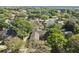 Aerial view of the home featuring a screened pool and lush landscaping at 9548 Crown Prince Ln, Windermere, FL 34786