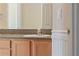 Bathroom with a light wood vanity, gray counter, and decorative wall trim at 9548 Crown Prince Ln, Windermere, FL 34786