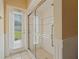 Bathroom featuring glass enclosed shower and exterior door providing natural light at 9548 Crown Prince Ln, Windermere, FL 34786