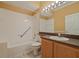 Bathroom with shower, tub, single sink vanity and Hollywood style lighting at 9548 Crown Prince Ln, Windermere, FL 34786