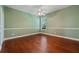 Bedroom featuring hardwood floors, a ceiling fan, and a window providing natural light at 9548 Crown Prince Ln, Windermere, FL 34786