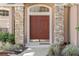 Elegant front door with stone pillars and meticulous landscaping at 9548 Crown Prince Ln, Windermere, FL 34786