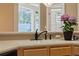 Kitchen sink and counter with black faucet fixture and view to the exterior at 9548 Crown Prince Ln, Windermere, FL 34786