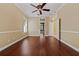 Spacious living room with hardwood floors, ceiling fan, and natural light at 9548 Crown Prince Ln, Windermere, FL 34786