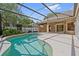 View of the screened pool with in-ground jacuzzi and lanai access at 9548 Crown Prince Ln, Windermere, FL 34786