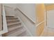 Carpeted staircase with white railings and adjacent tiled hallway at 9548 Crown Prince Ln, Windermere, FL 34786