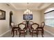 Elegant dining room with tray ceiling, chandelier, and seating for six at 11800 Buttonhook Dr, Clermont, FL 34711