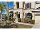 Well-manicured lawn highlights the home's exterior and attached two-car garage at 11800 Buttonhook Dr, Clermont, FL 34711