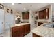 Spacious kitchen with granite countertops and custom wood cabinetry at 11800 Buttonhook Dr, Clermont, FL 34711