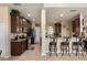 Open kitchen with breakfast bar, stainless appliances and dark wood cabinets at 11800 Buttonhook Dr, Clermont, FL 34711