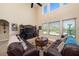 Bright living room with high ceilings, large windows and comfortable leather sofas at 11800 Buttonhook Dr, Clermont, FL 34711