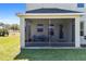 Screened porch with seating provides a cozy outdoor retreat at 11800 Buttonhook Dr, Clermont, FL 34711