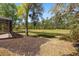 Backyard view with screened pool, landscaped grounds and serene water feature at 1185 Cypress Loft Pl, Lake Mary, FL 32746