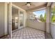 View of the balcony with patterned outdoor rug and screened window overlooking a nearby roof at 1185 Cypress Loft Pl, Lake Mary, FL 32746