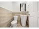 Modern half-bath features elegant wood-look tile wainscoting and a pedestal sink at 1185 Cypress Loft Pl, Lake Mary, FL 32746