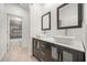 Bathroom featuring dual vessel sinks on a dark vanity and a view into the shower area at 1185 Cypress Loft Pl, Lake Mary, FL 32746