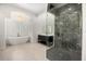 Bright bathroom features a modern tub, sleek vanity, and a frameless glass shower with gray marble tile at 1185 Cypress Loft Pl, Lake Mary, FL 32746