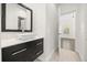 Modern bathroom with a floating vanity, vessel sink, and view into bedroom at 1185 Cypress Loft Pl, Lake Mary, FL 32746