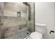 Glass enclosed shower with gray tile and body jets and adjacent toilet at 1185 Cypress Loft Pl, Lake Mary, FL 32746