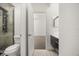 Bathroom with toilet, vanity, and a glass-enclosed shower with body jets at 1185 Cypress Loft Pl, Lake Mary, FL 32746