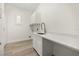 Bright laundry room with white cabinets, countertops, and modern fixtures at 1185 Cypress Loft Pl, Lake Mary, FL 32746