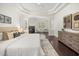 Well-lit main bedroom features dark wood floors, fireplace, and stylish furnishings at 1185 Cypress Loft Pl, Lake Mary, FL 32746