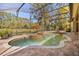 A pristine pool features a rock fountain, complemented by views of the surrounding lush landscape at 1185 Cypress Loft Pl, Lake Mary, FL 32746