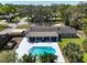 Aerial view of a home featuring a screened lanai, a backyard pool, and lush landscaping at 1285 Seminole Ave, Longwood, FL 32750