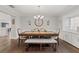 Bright dining room with modern chandelier and seating for six, adjacent to a buffet cabinet and open to the kitchen at 1285 Seminole Ave, Longwood, FL 32750