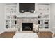 Brick fireplace with built-in shelving, and a mounted TV, making it a cozy focal point in the living room at 1285 Seminole Ave, Longwood, FL 32750