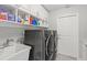 Well-organized laundry room with modern appliances and ample storage space for cleaning supplies at 1285 Seminole Ave, Longwood, FL 32750