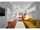 Spacious bedroom showcases vaulted ceilings, wood floors, and a seating area with a comfortable yellow sofa at 1519 N Westmoreland Dr, Orlando, FL 32804