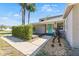 Charming home featuring a welcoming, light-blue front door and well-maintained landscaping, complemented by gravel and palm trees at 1519 N Westmoreland Dr, Orlando, FL 32804