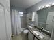 Bathroom with granite vanity, shower-tub combo with white tiling at 2020 Royal Bay Blvd # 92, Kissimmee, FL 34746