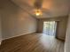Spacious bedroom boasts vaulted ceiling and sliding glass doors to a balcony at 2020 Royal Bay Blvd # 92, Kissimmee, FL 34746