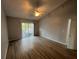 Bedroom with hardwood floors, ceiling fan, and a sliding glass door to the balcony at 2020 Royal Bay Blvd # 92, Kissimmee, FL 34746