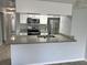 Open kitchen with granite countertops, stainless steel appliances and breakfast bar at 2020 Royal Bay Blvd # 92, Kissimmee, FL 34746