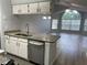 Open kitchen with granite countertops, stainless steel appliances, and hardwood floors at 2020 Royal Bay Blvd # 92, Kissimmee, FL 34746