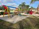 Bright and colorful playground with slides, swings, and climbing equipment surrounded by sand at 2020 Royal Bay Blvd # 92, Kissimmee, FL 34746