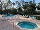 Community pool and hot tub with lounge chairs at 2020 Royal Bay Blvd # 92, Kissimmee, FL 34746