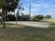 Exterior photo of community sand volleyball court with a net, bordered by mature trees and a lawn at 2020 Royal Bay Blvd # 92, Kissimmee, FL 34746