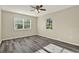 Bright bedroom with wood-look flooring, two windows and neutral-colored walls at 2202 Clubside Dr # 2202, Longwood, FL 32779