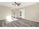 Spacious bedroom featuring hardwood floors, a ceiling fan, and an attached bathroom with updated finishes at 2202 Clubside Dr # 2202, Longwood, FL 32779