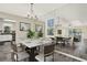 Elegant dining area featuring a modern table set, stylish chandelier, and decorative wall art at 2202 Clubside Dr # 2202, Longwood, FL 32779