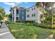 Well-maintained apartment building exterior with lush landscaping, garden, and walkways in a beautiful community at 2202 Clubside Dr # 2202, Longwood, FL 32779