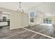 Expansive living room featuring wood floors, white kitchen cabinets, and mirrored walls at 2202 Clubside Dr # 2202, Longwood, FL 32779